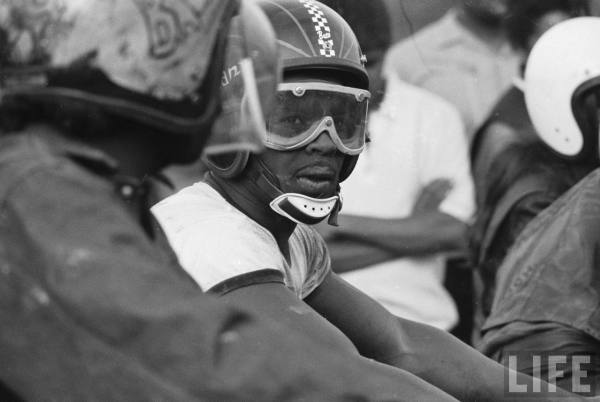 African American motorcycle enthusiast belonging to the Big Circle Motorcycle Association prepares to ride-- circa 1971.