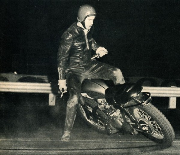 Kenny Brown, the mad motorcycyle trick-rider is seen here tearing it up on a Triumph. 