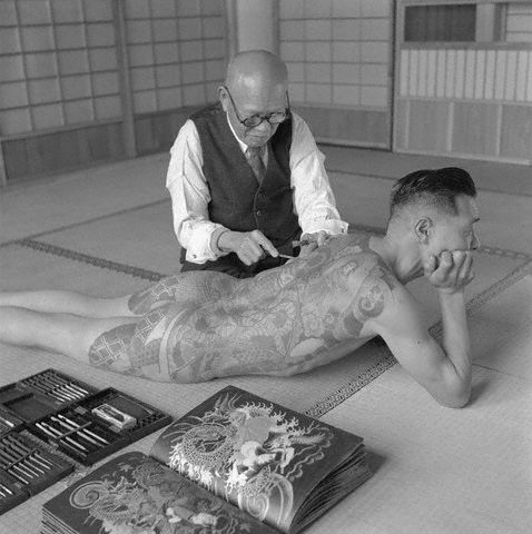 1946 Tokyo Japan A Japanese tattoo artist works on the shoulder of a 