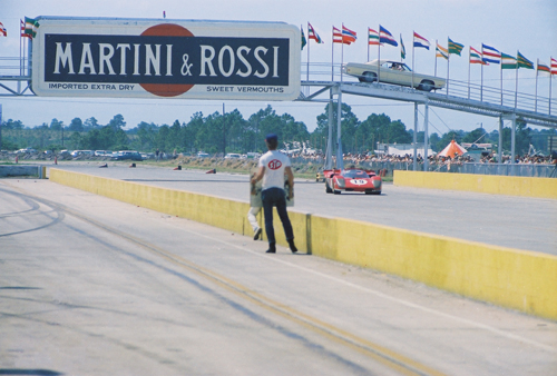 The Martini & Rossi vehicle bridge just yards from the start/finish line. The car in the picture is the #19 Ferrari of Mario Andretti and Arturo Merzario. The car was leading at the time I took the photo. The car had mechanical problems later and Andretti jumped to the #21 Ferrari 512 for the win just 22 seconds ahead of Steve McQueen and Peter Revson's Porsche. 